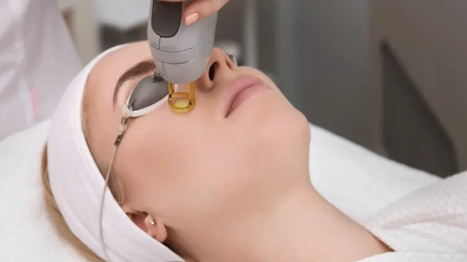CO2 fractional laser resurfacing device treating scarred and sun-damaged skin